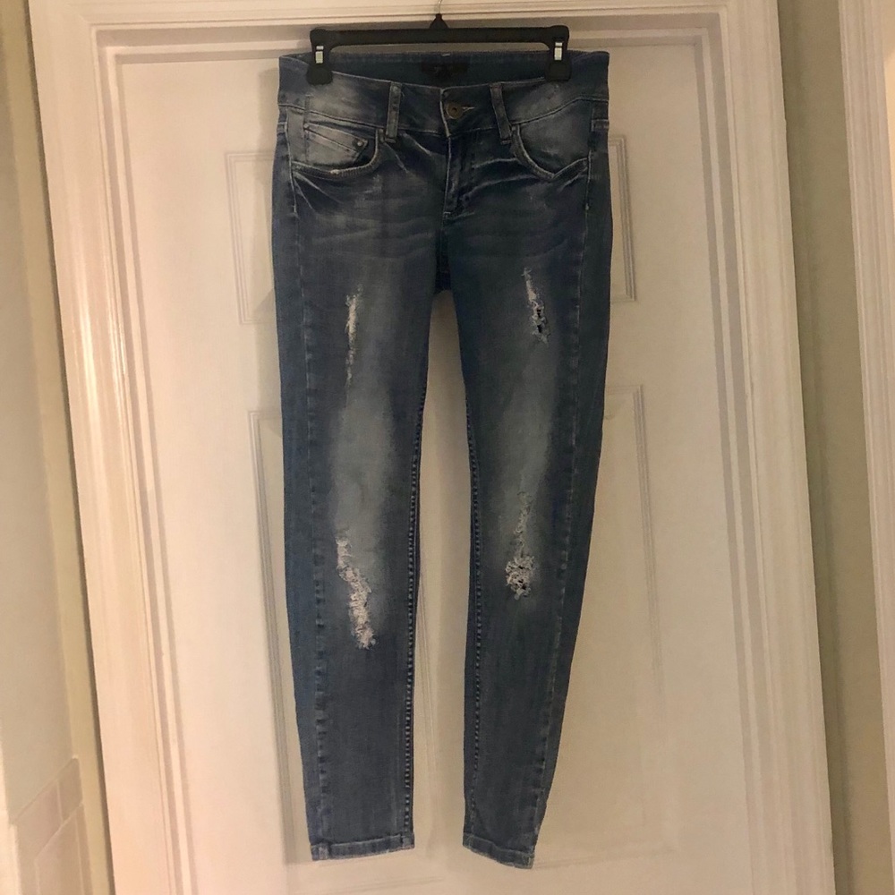 Distressed denim jeans